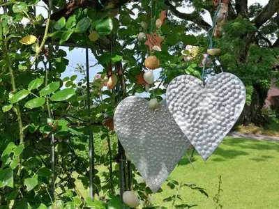two hearts hanging from a tree in a garden at Apartment Studio Ferienwohnung - 38 m2- mit Gartennutzung by Interhome in Bottighofen