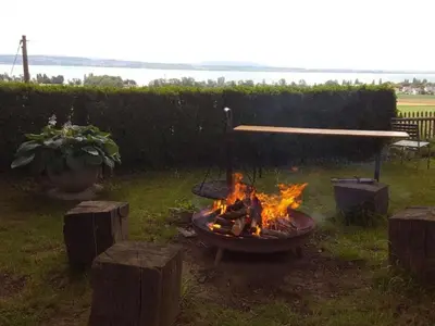 a fire pit in a yard with flames in it at Apartment Studio Ferienwohnung - 38 m2- mit Gartennutzung by Interhome in Bottighofen
