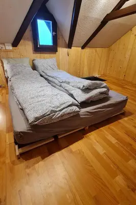a bed sitting in a room with a window at Holiday Home Bienenhaus Speicher by Interhome in Speicher