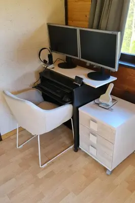 a desk with two computer monitors and a chair at Holiday Home Bienenhaus Speicher by Interhome in Speicher