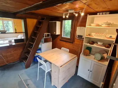 a small kitchen and dining room in a tiny house at Holiday Home Bienenhaus Speicher by Interhome in Speicher
