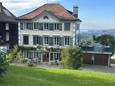 a large house on top of a green hill at Apartment Allegra Appenzell by Interhome in Trogen