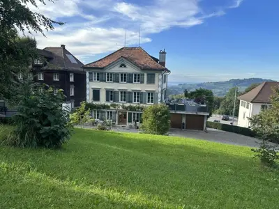 a large house with a green lawn in front of it at Apartment Allegra Appenzell by Interhome in Trogen