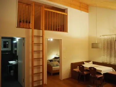 a room with a loft bed and a bedroom at Apartment Ballmoos Ferienwohnung by Interhome in Gais
