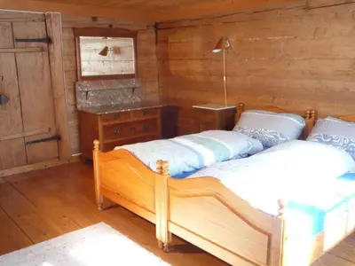 two beds in a room with wooden walls at Holiday Home Appenzell House by Interhome in Thal