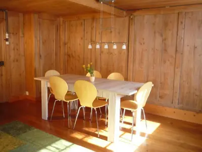 a dining room with a table and yellow chairs at Holiday Home Appenzell House by Interhome in Thal