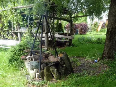 a garden with a tree and a swing at Holiday Home das schiefe Haus by Interhome in Oberschan