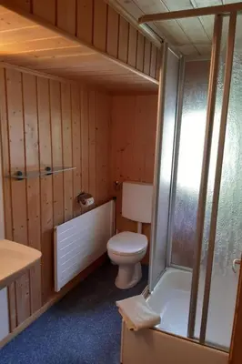 a bathroom with a toilet and a tub and a sink at Apartment Löhli Hof by Interhome in Lienz