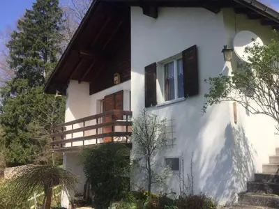 a large white house with a window and stairs at Holiday Home Feriehüsli by Interhome in Krummenau
