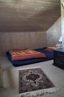 a room with a bed and a rug in a room at Holiday Home Feriehüsli by Interhome in Krummenau
