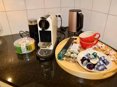 a counter top with a plate of food and a toaster at Apartment Panoramablick by Interhome in Nesslau