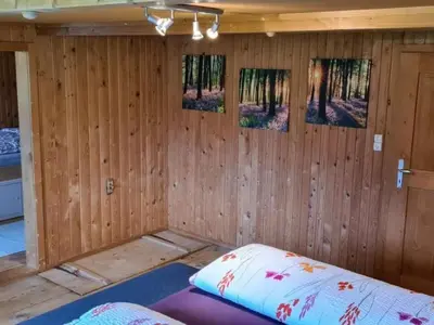 a room with wooden walls and a bed in it at Holiday Home Seuzach by Interhome in Nesslau