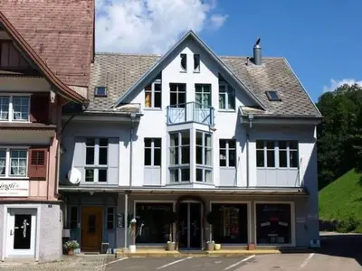 a white house with a balcony on a street at Apartment Zwingli's Ferienwohnung by Interhome in Nesslau