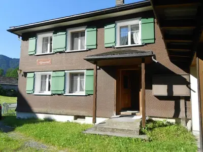a small house with a door and a porch at Holiday Home Alpenrösli in Nesslau by Interhome in Nesslau