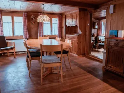 a dining room with a wooden table and chairs at Holiday Home Alpenrösli in Nesslau by Interhome in Nesslau