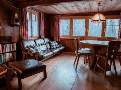 a living room with a couch and a table at Holiday Home Alpenrösli in Nesslau by Interhome in Nesslau