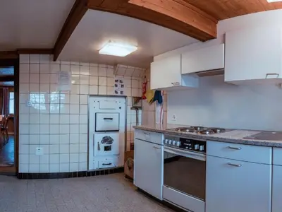 a kitchen with white appliances and white cabinets at Holiday Home Alpenrösli in Nesslau by Interhome in Nesslau
