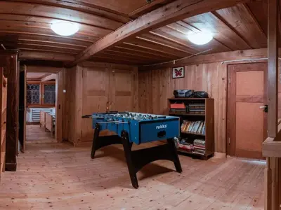 a ping pong table in a room with wooden walls at Holiday Home Alpenrösli in Nesslau by Interhome in Nesslau