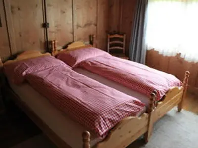 a bed with two pink sheets and a window at Holiday Home Obere Laui by Interhome in Nesslau