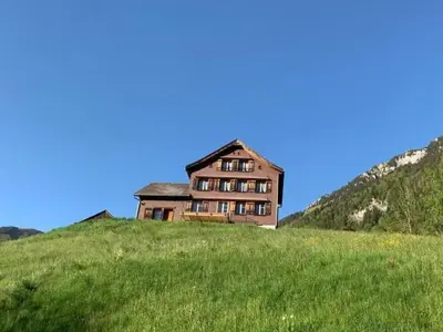 an old house on top of a grassy hill at Holiday Home Ferienhaus by Interhome in Nesslau