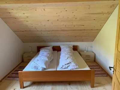 a bed in a room with a wooden ceiling at Holiday Home Ferienhaus by Interhome in Nesslau