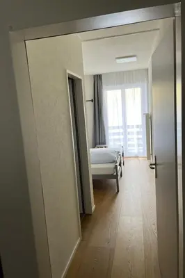 an open door to a bedroom with a bed and a window at Apartment Terrasse & Pistenähe by Interhome in Alt Sankt Johann
