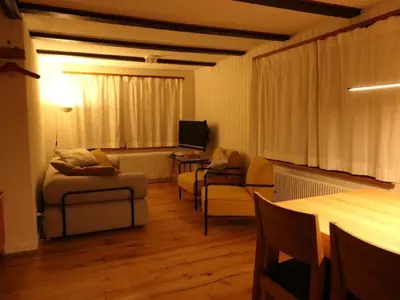 a living room with a couch and chairs and a television at Holiday Home Oberguet by Interhome in Unterwasser
