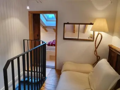 a living room with a couch and a mirror at Holiday Home Oberguet by Interhome in Unterwasser