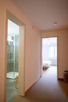 an empty room with a door leading to a bedroom at Holiday Home Haus am Schwendisee by Interhome in Wildhaus