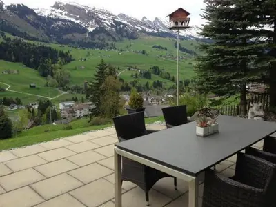 a table and chairs with a view of a mountain at Holiday Home Höckli by Interhome in Wildhaus