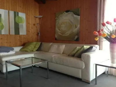 a living room with a couch and a table at Holiday Home Höckli by Interhome in Wildhaus