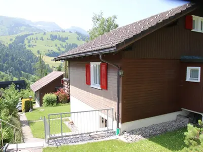 a house in the mountains with red shutters at Apartment Chalet Lilian by Interhome in Unterwasser