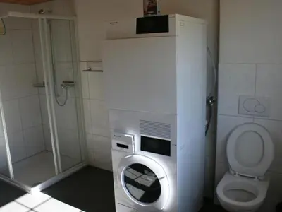 a bathroom with a washing machine and a toilet at Apartment Bädli by Interhome in Wildhaus
