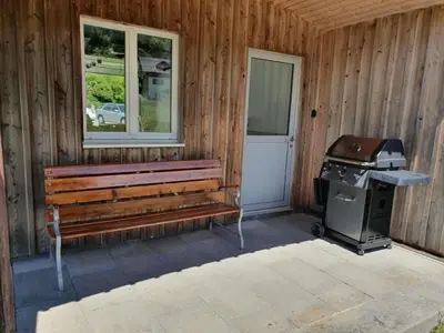 a grill and a bench outside of a house at Apartment Bädli by Interhome in Wildhaus