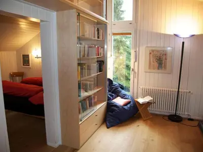 a room with a book shelf filled with books at Holiday Home Befang 17 by Interhome in Wildhaus