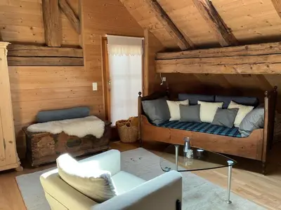a room with a bed and a couch and a table at Charming Retreat for Nature Lovers near Saxerlücke in Sennwald