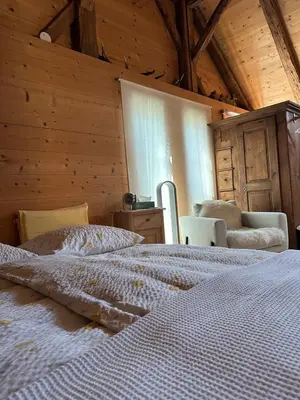 a bedroom with a large bed and a window at Charming Retreat for Nature Lovers near Saxerlücke in Sennwald