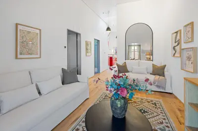 a living room with a white couch and a vase with flowers at BLIV Exklusive Dachgeschosswohnung im Zentrum in St. Gallen