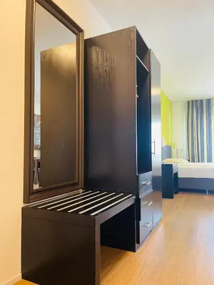 a room with a large mirror and a bed at Hotel Swiss Bellevue in Kreuzlingen