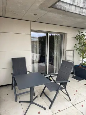 a living room with a flat screen tv on the wall at Comfort Rooms mit Whirlpoolzugang in Romanshorn