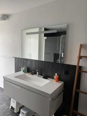 a walk in closet with a glass door and hangers at Comfort Rooms mit Whirlpoolzugang in Romanshorn