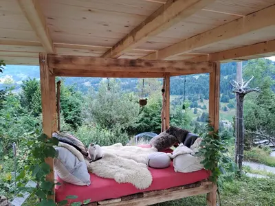 a black dog laying on the floor in a room at Säntis Chalet Chnorz Apartment in Nesslau