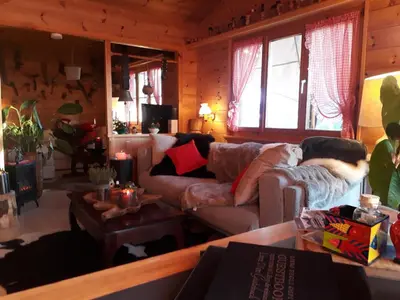 a living room with a couch and a table at Säntis Chalet Chnorz Apartment in Nesslau