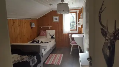 a bedroom with a bed in a small room at Chalet Chic mit Hot Pot in Wildhaus