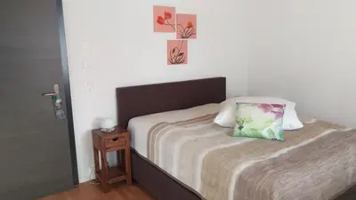 a bedroom with a bed with a pillow on it at Hotel Enjoy in Goldach