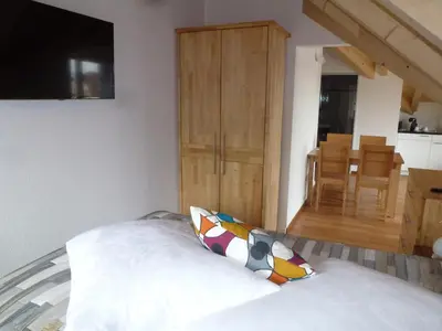 a bedroom with a bed and a dining room at Hotel Enjoy in Goldach