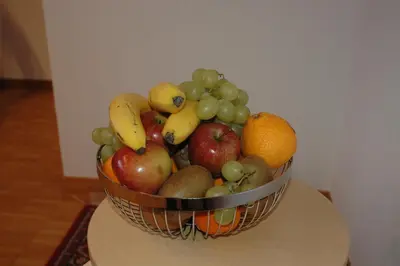 a basket of fruit sitting on a table at Hotel Pension Im Dorf in Zuzwil