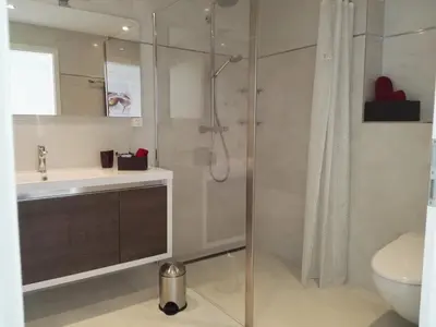 a bathroom with a shower and a sink and a toilet at Sunrise Apartment in Staad