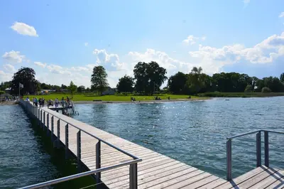 people standing on a dock near a body of water at Landgasthof Seelust in Egnach