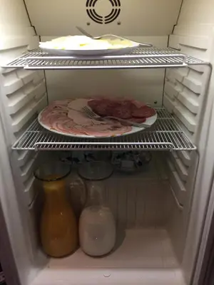 a refrigerator with some food and a plate of food at Landgasthof Werdenberg in Werdenberg